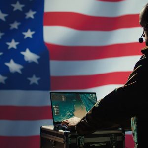 US Air Force agent using radar system on laptop to detect incoming ballistic missiles. American NATO army soldier scanning rockets approaching borders, deploying shields, United States flag, camera B