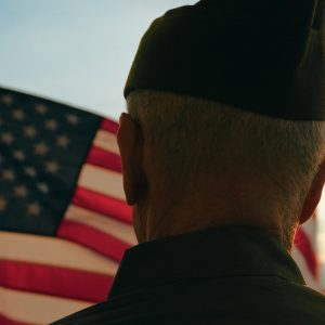 Veteran soldier senior old man against the American flag